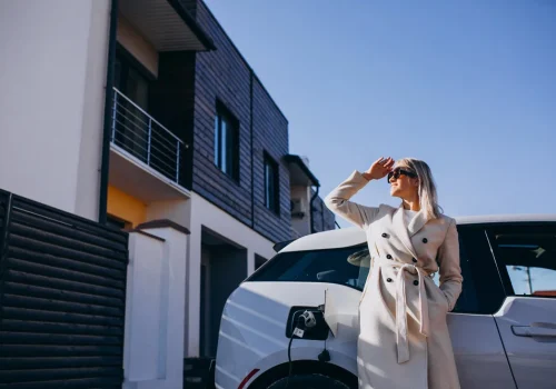 woman-charging-electro-car-by-her-house